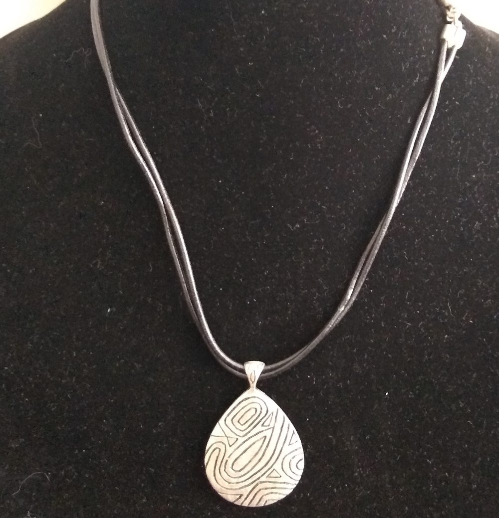 Vintage Chico’s silver tone Carved disc on Black cord  necklace
